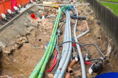 Underground urban pipe engineering in a long roadside trench.