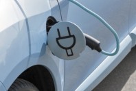 Charging an electric car with the power cable supply plugged in, closeup