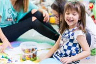 Cheerful pre-school girl wearing a trendy T-shirt while playing
