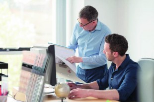 Male colleagues in discussion at office desk