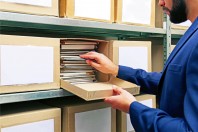 Man with documents in archive