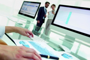 close-up of a business woman working with financial charts in a modern office
