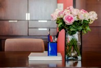 Working table with vase of roses in modern room