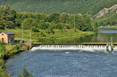 Landscape with a dam on Meuse river in Ardennes, France near Fumay in sunny summer day