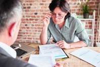 Colleagues in office discussing paperwork