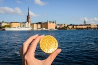 Sweden chocolate coins with Stockholm on blurred background