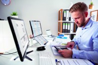 Businessperson Calculating Invoice