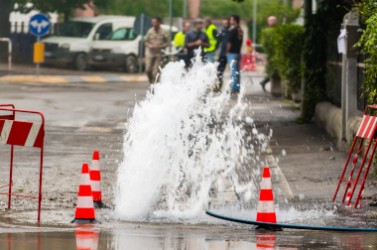 road spurt water beside traffic cones