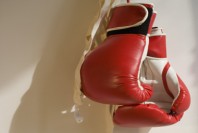 Red Boxing Gloves Hanging on Wall