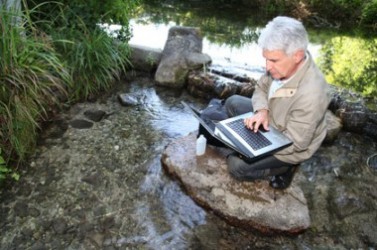 Biologist testing quality of stream water