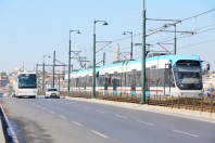 Tram, bus and car at sunny summer day on streets