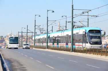 Tram, bus and car at sunny summer day on streets