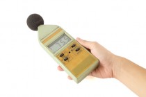 old sound level meter holding on hand