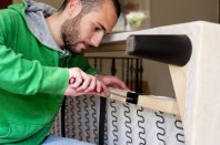 Man repairing a sofa