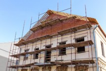 Old historic building facade under reconstruction with scaffolding