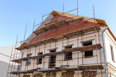 Old historic building facade under reconstruction with scaffolding